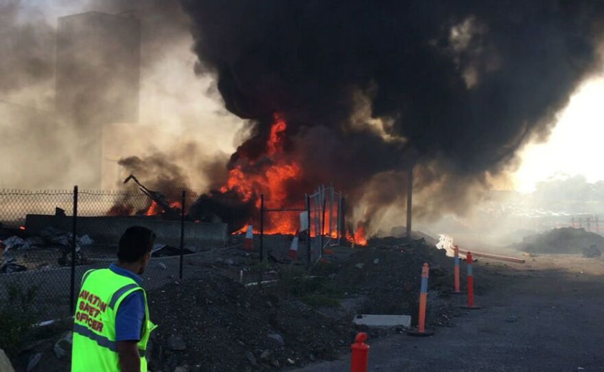 Smoke and flames rise after a Beechcraft plane crashed into a shopping center after it took off from Essendon Airport in suburban Melbourne, Australia.