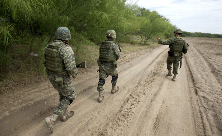 Soldiers patrol the banks of the Rio Grande on the outskirts of Tamaulipas state, Mexico. The rampant drug cartel-related violence is another deterrent to wide-scale foreign investment.