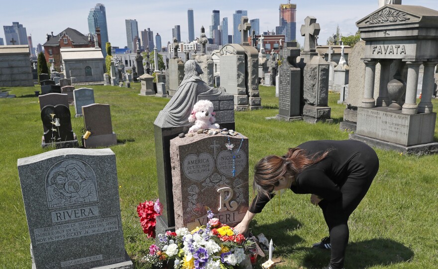 Sharon Rivera adjusts flowers at the grave of her daughter, Victoria, at Calvary Cemetery in New York last Mother's Day. Victoria died of a drug overdose in 2019, when she was 21. According to new data released by the Centers for Disease Control and Prevention, drug overdose deaths soared to a record of more than 93,000 last year.