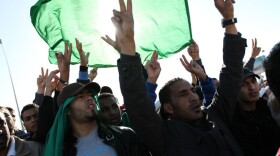 Men in Tripoli join in the part-protest, part-funeral for civilians said to have died during recent airstrikes in Libya. They gathered at a place along Libya's Mediterranean coast known as a cemetery for martyrs.
