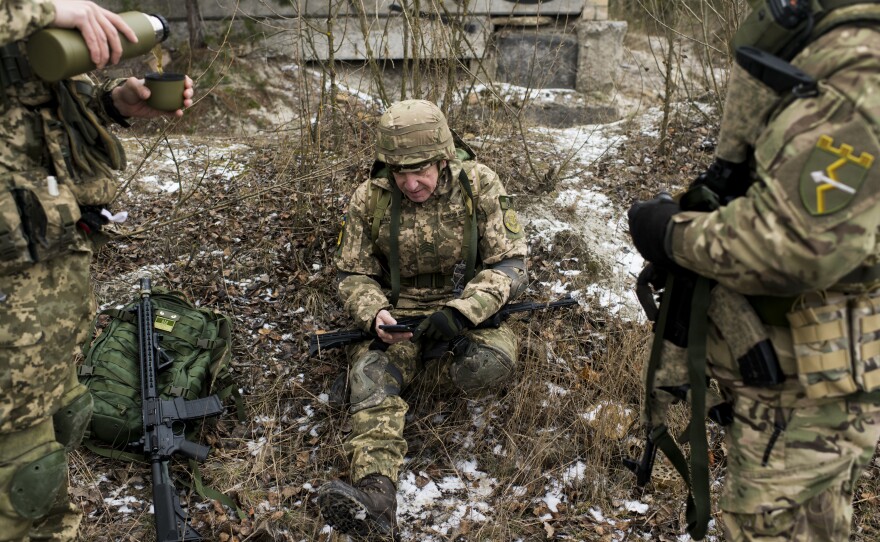 Members of the Territorial Defense Forces take a break during training. Many of the volunteers are old enough to remember when Russians and Ukrainians were Soviet brothers.
