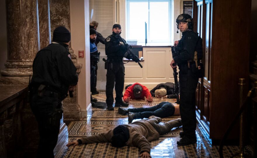 U.S. Capitol Police officers detain protesters outside of the House Chamber during a joint session of Congress on Jan. 6, 2021. Congress held a joint session to ratify Joe Biden's 306-232 Electoral College win over Donald Trump.