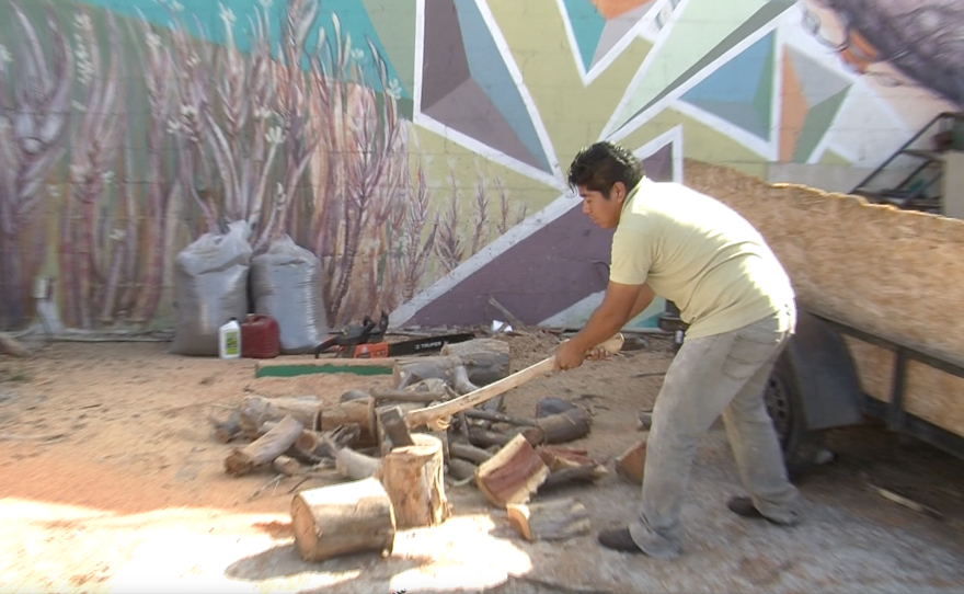 A employee at Verde Y Crema in Tijuana chops olive wood for cooking, June 3, 2015.