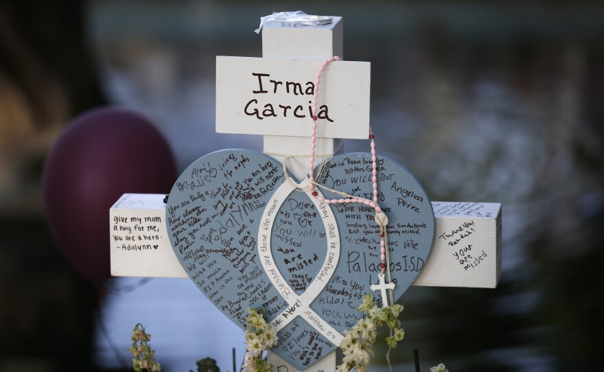 Irma Garcia's cross stands at a memorial site for the victims killed in this week's shooting at Robb Elementary School in Uvalde, Texas.