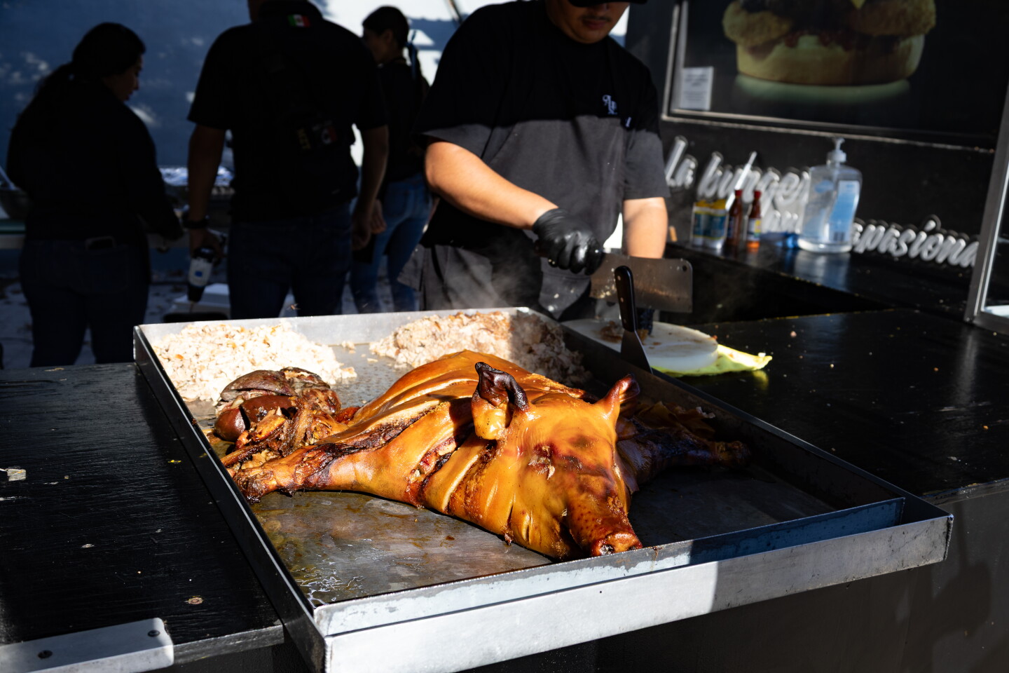 A man chops up pork for tacos at Toros Mobil Park in Tijuana, Mexico, July 31, 2026.