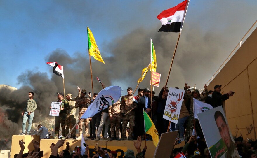 Protesters set fires in front of the U.S. Embassy compound in Baghdad on Tuesday.