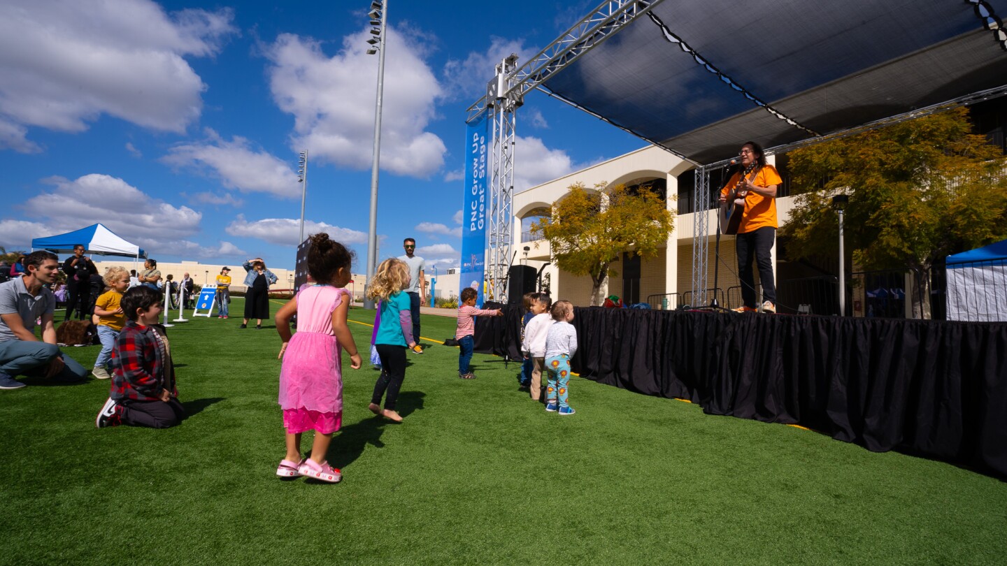 Children sing and dance with Ralph of Ralph's World at Be My Neighbor Day across the street from the KPBS station on Saturday, April 6 in San Diego, CA.