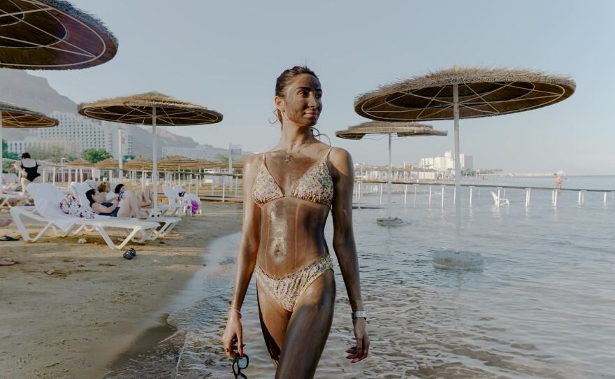 An Israeli visitor at a Dead Sea hotel resort poses with mineral-rich Dead Sea mud lathered on her skin on Nov. 10.