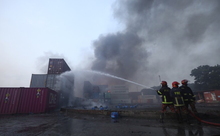 Firefighters work to contain a fire that broke out at the BM Inland Container Depot, a Dutch-Bangladesh joint venture, in Chittagong, Bangladesh, early Sunday.