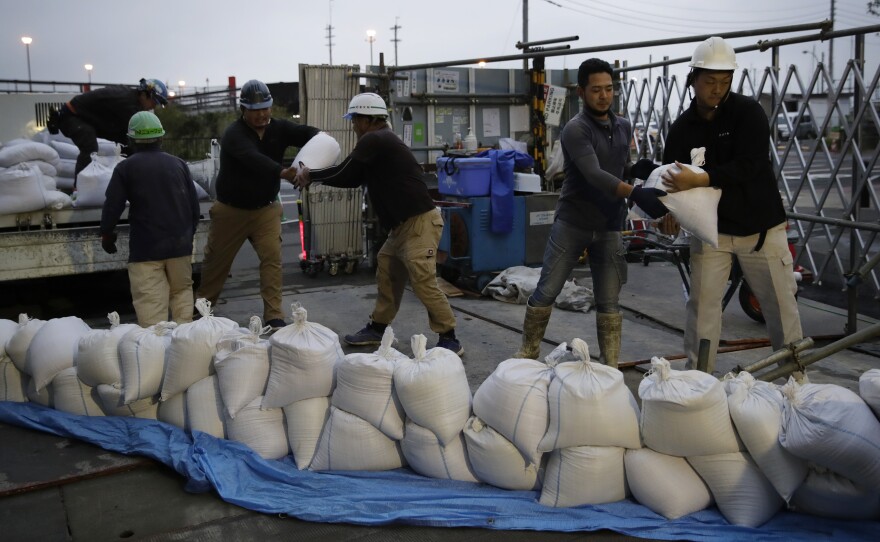 Workers stack sandbags at a construction site in preparation for Typhoon Hagibis on Enoshima Island, Kamakura, west of Tokyo on Friday. (AP Photo/Jae C. Hong)