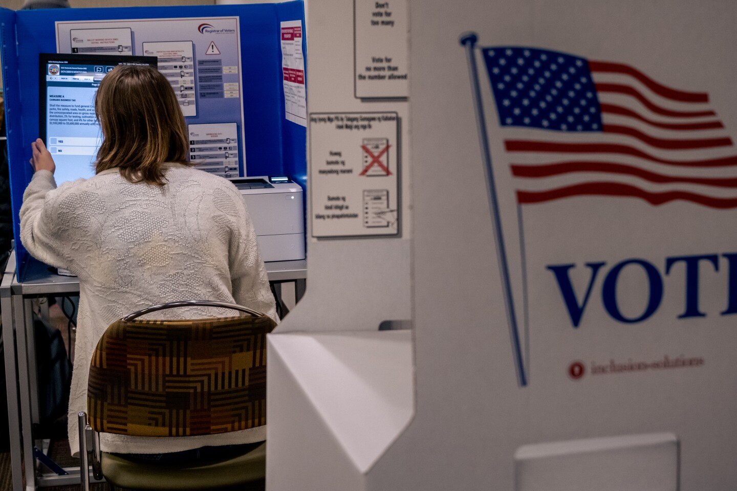 A San Diego State University student waited in line for over an hour to register and cast her first ballot at the on-campus polling place at SDSU, Nov. 8, 2022.