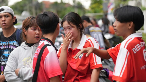A schoolgirl cries outside her school where deaths and injuries were reported after a shooting in Thailand's Nonthaburi province, Friday, Aug. 7, 2026.