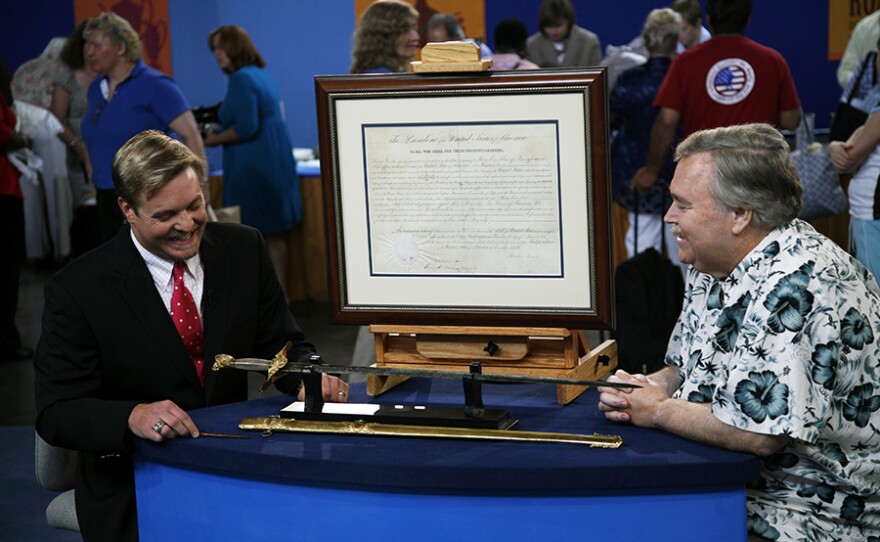 Rafael Eledge (left) appraises a presentation sword and Lincoln-signed appointment in Baltimore, Md. ANTIQUES ROADSHOW “Vintage Baltimore 2021 Hour 1” premieres Monday, January 11 on PBS.