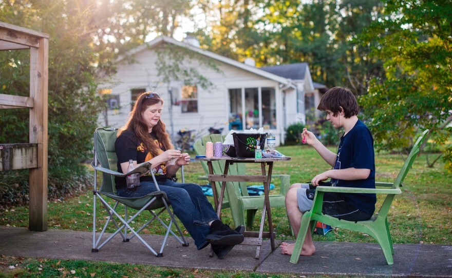 Griffin and her oldest son, Griffin Shade, 13, make Halloween treats outside their home.