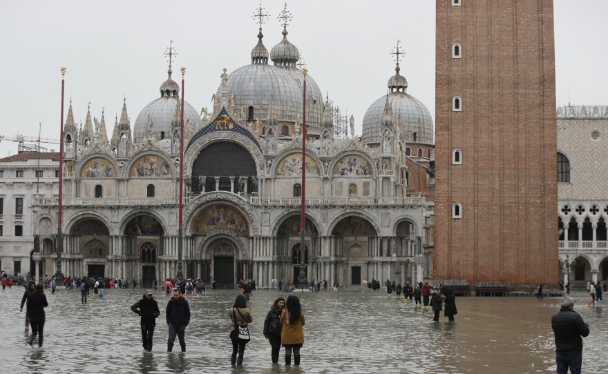 People in front of St. Mark's Basilica wade in flood water in Venice on Wednesday.