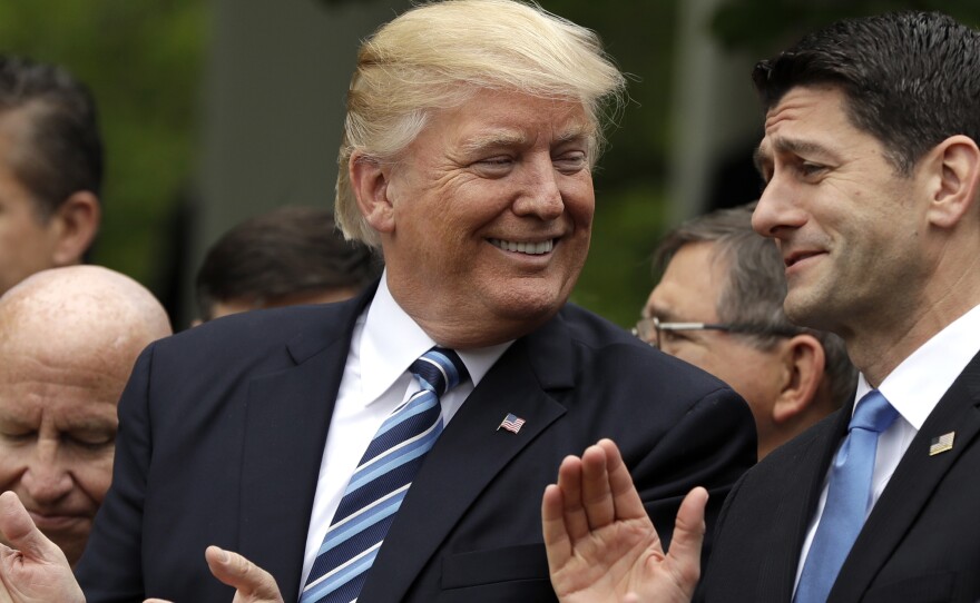 President Donald Trump celebrates with House Speaker Paul Ryan in the White House Rose Garden Thursday after the House voted to pass the American Health Care Act.