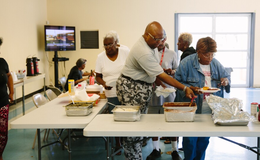 Patrons of the Sojourner Truth Community Center in the Faubourg Lafitte housing development help themselves to free red beans and rice and greens. The center provides a community space for the development and programs to encourage interaction between residents.