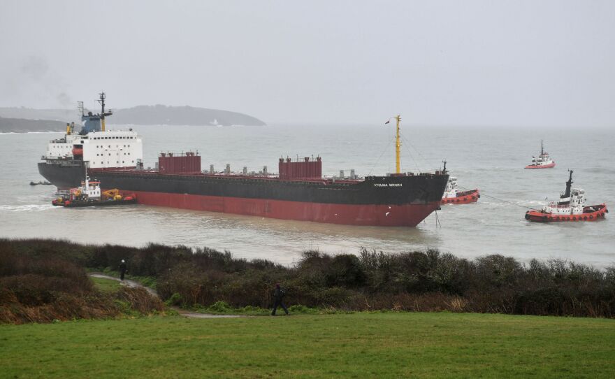 The Kuzma Minin was grounded Tuesday morning a few hundred feet from a British beach. Smaller boats were eventually able to help pull it free.