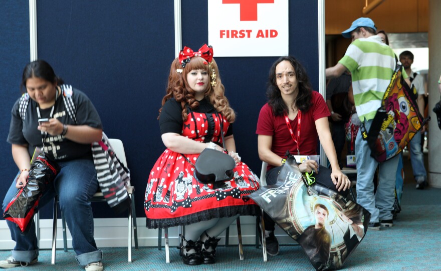 A woman dressed in the Lolita style takes a rest during 2011 Comic-Con International.