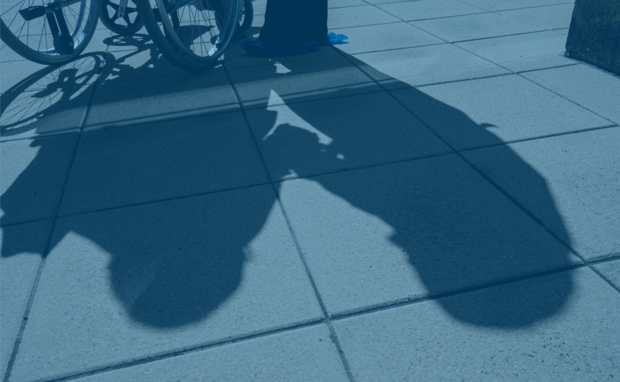 The shadow of a person in a wheelchair and their caregiver is pictured in this undated image.