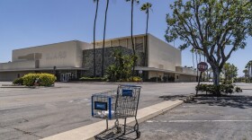 This Thursday, May 27, 2021, photo shows an empty shopping cart in an empty parking lot at the closed Sears in Buena Park Mall in Buena Park, Calif. 