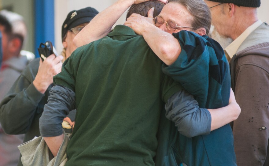 A Sparks Middle School student cries with family members after a fellow student killed a math teacher and himself Monday in Sparks, Nev.