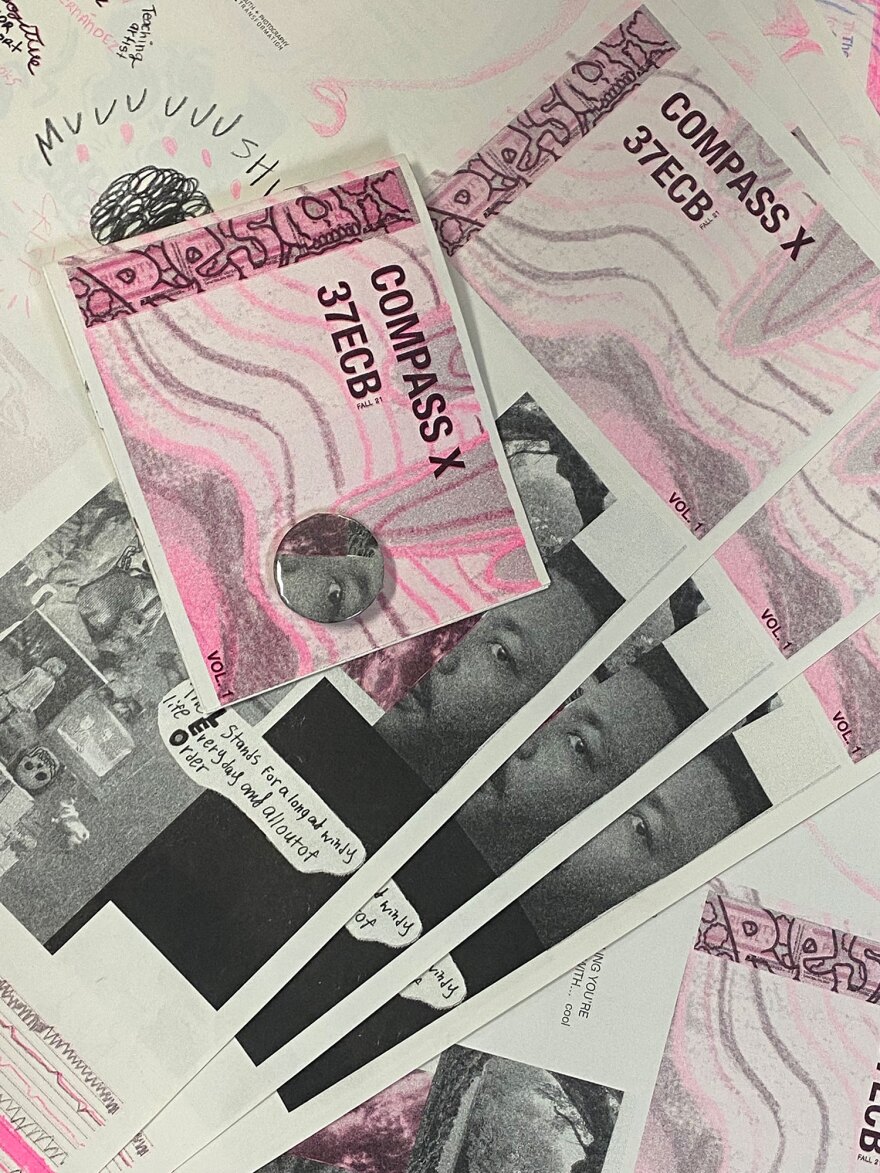 Copies of the Compass Community Circle zine are shown in an undated photo.