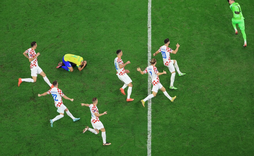 Croatia players celebrate their win via a penalty shootout as Marquinhos of Brazil reacts to missing his kick during the World Cup quarterfinal match between Croatia and Brazil.