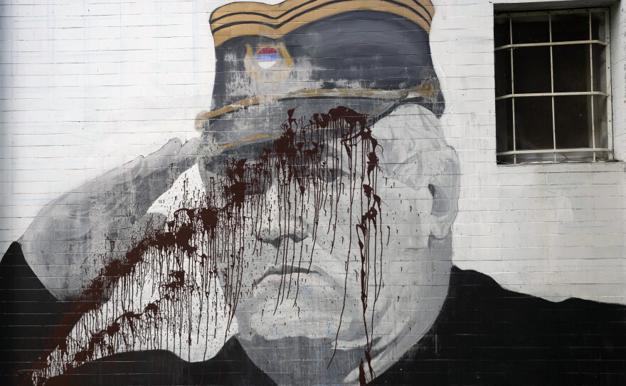 A mural of former Bosnian Serb military chief Ratko Mladic vandalized with paint in Belgrade, Serbia, Sept. 20, 2022.
