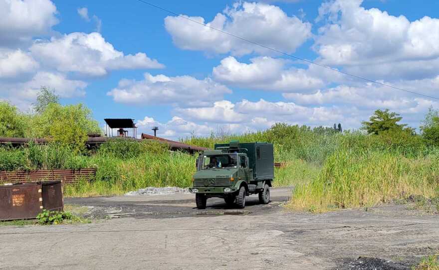 A Ukrainian ambulance drives to a rendezvous point near an abandoned factory in the "gray  zone," where it will wait for wounded soldiers being evacuated from the front lines.
