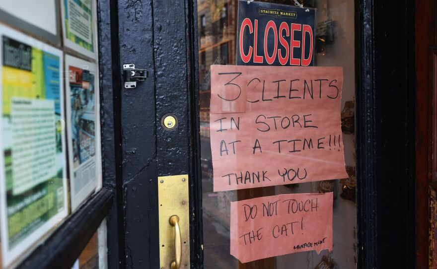 A butcher shop in the Brooklyn borough of New York shows a "Closed" sign, limiting customers to three at a time. Gov. Andrew Cuomo is ordering all nonessential businesses to close, in an escalation of the state's attempts to contain the COVID-19 pandemic.