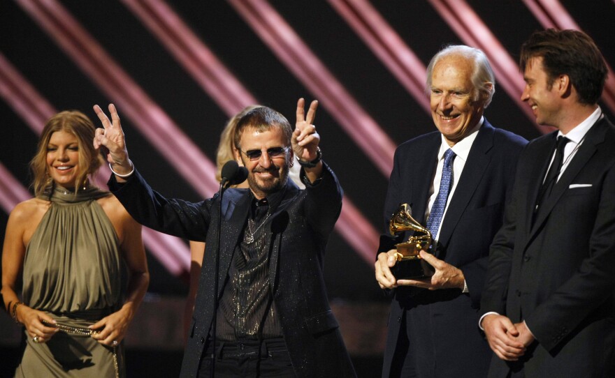Ringo Starr celebrates as producer George Martin holds the trophy for Best Compilation Soundtrack Album at the Grammy Awards in 2008.
