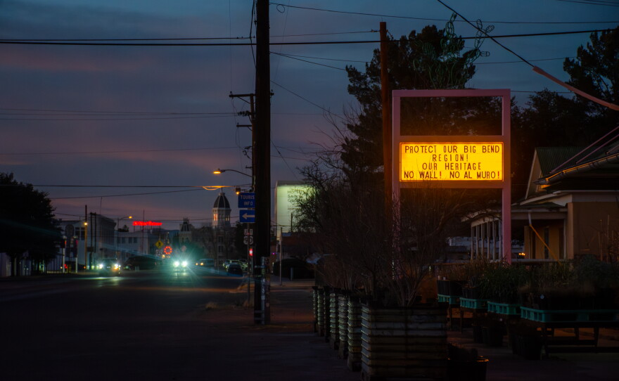 Across the Big Bend, anti-wall signs, flyers and messages have popped up in homes and businesses, like this liquor store in Marfa, Texas.