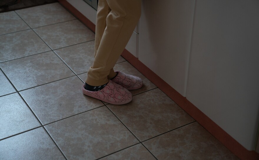 A Ukrainian foster girl stands in the kitchen of a Polish foster home. A group of four adults and 17 foster children crossed the border from Ukraine to Poland together.