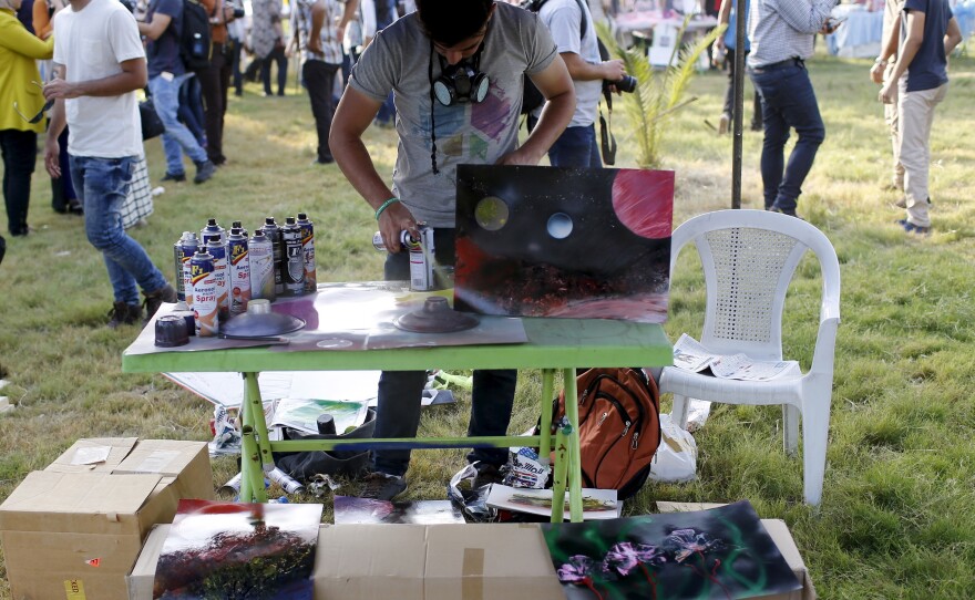 A man paints at the City of Peace Carnival. The event has grown over the last five years to include 500 volunteers, corporate sponsorship and many acts.