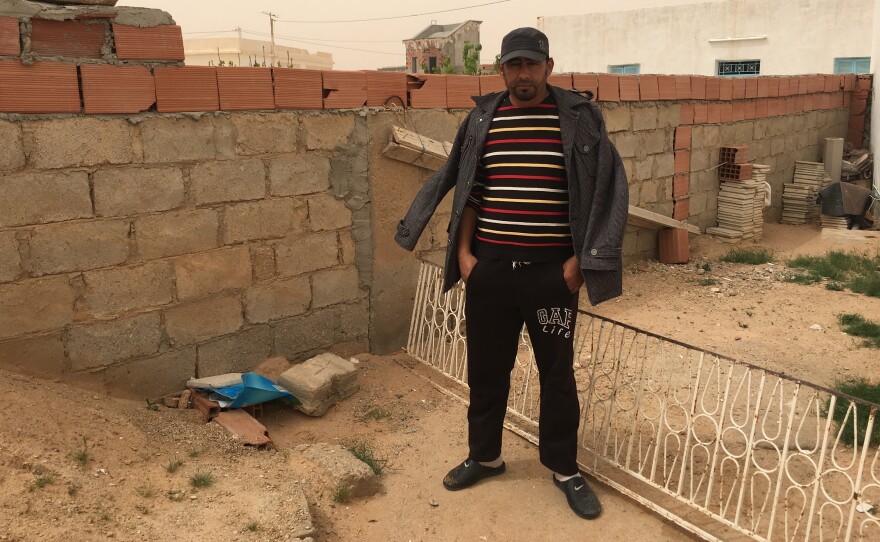 Jilan Abdul Kabir stands next to the spot where his cousin Abdul Atti al-Kabir was shot and killed by ISIS militants in a battle earlier this month in southern Tunisia, near the Libyan border.