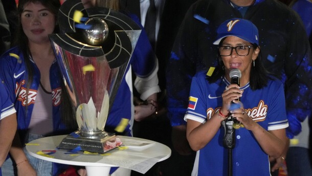 Venezuela's acting President Delcy Rodriguez, right, speaks next to the World Baseball Classic trophy a day after her team's victory over the United States in the championship match, at Miraflores presidential palace in Caracas, Venezuela, Wednesday, March 18, 2026.