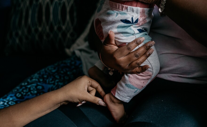 Cassie Washington holds her youngest daughter, Cali, who is 8 months old. Washington has been in a healthy two-year relationship with her partner.