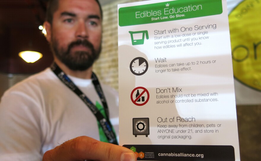 Maka Kalaí, the manager of Organic Alternatives, a recreational and medical marijuana store in Fort Collins, Colo., hands out edible education cards with each purchase.