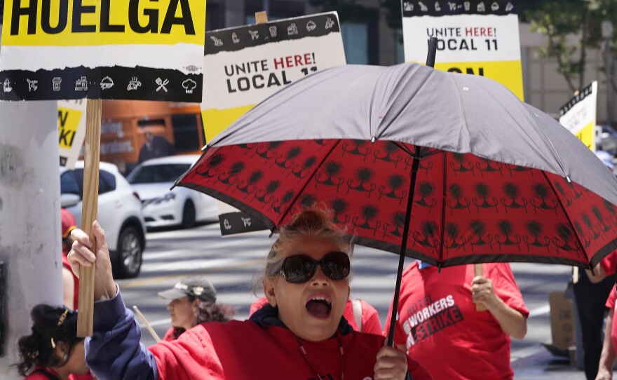Striking hotel workers rally outside the InterContinental Los Angeles Downtown Hotel on Tuesday, July 4, 2023. (AP Photo/Damian Dovarganes)