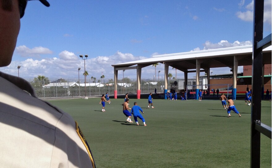 A guard watches as detainees exercise at the Florence facility. Housing one detainee costs at least $120 per day.