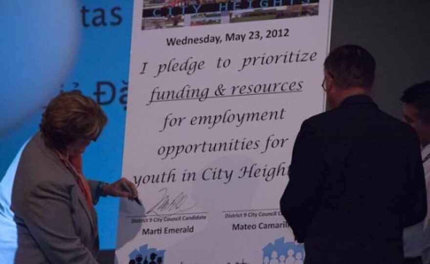 City Council District 9 candidates Marti Emerald and Mateo Camarillo sign a pledge promising to bring more youth jobs to City Heights.