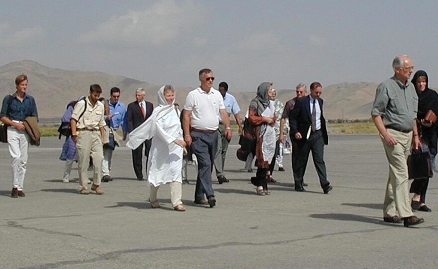 Diplomats and family members of the detained aid workers walk to their plane at Kabul airport to leave for Pakistan on Sept. 13, 2001. John Mercer, father of one detained aid worker, is in the white shirt in the center. The few foreigners in Afghanistan left the country after the Sept. 11 attacks in the U.S. The Taliban said they could not guarantee their safety.