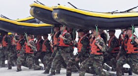 Navy SEAL trainees carry inflatable boats at the Naval Amphibious Base Coronado in Coronado, Calif., May 14, 2009. 