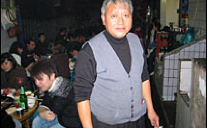 Owner Zhao Zhenshuan personally mixes the special cooking brew at his restaurant.