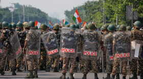 Security personnel in riot gear arrive to escort workers of India's opposition Congress party as they gather for a march toward the Supreme Court demanding the resignation of Chief Election Commissioner Gyanesh Kumar in New Delhi, India, on Monday.