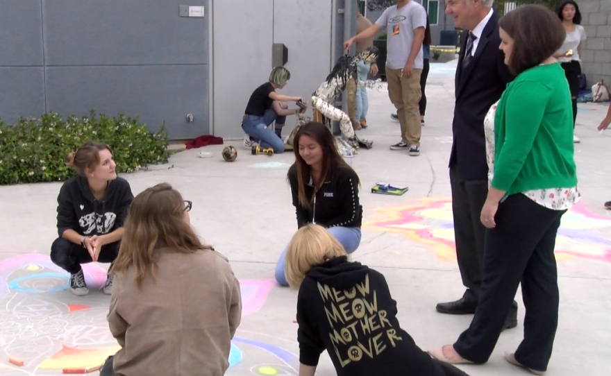 Del Norte High School special education teacher Megan Gross and State Superintendent of Public Instruction Tom Torlakson talk with art students who are preparing for a school festival, June 1, 2017.