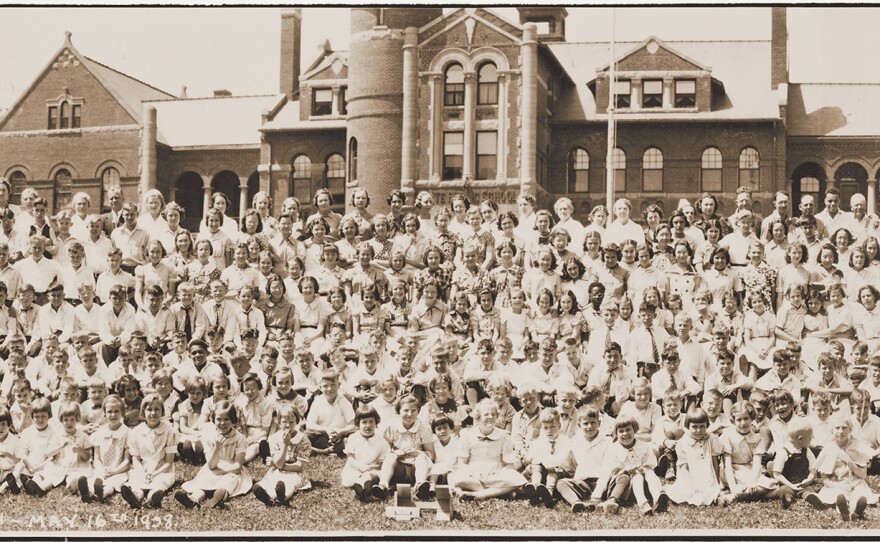 Children and staff stand in front of the Minnesota State Public School for Dependent and Neglected Children administration building in 1938.