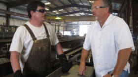Precision Iron Works President Steve Leighton (right) says government regulations are keeping his company from growing.