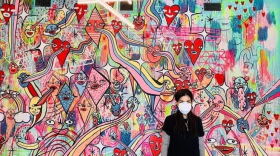 Paola Villaseñor, an artist better known as Panca, is pictured by one of her paintings in this undated photo. 